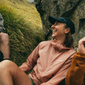 Woman laughing wearing Montane Featherlite Hooded Jacket Pink clay